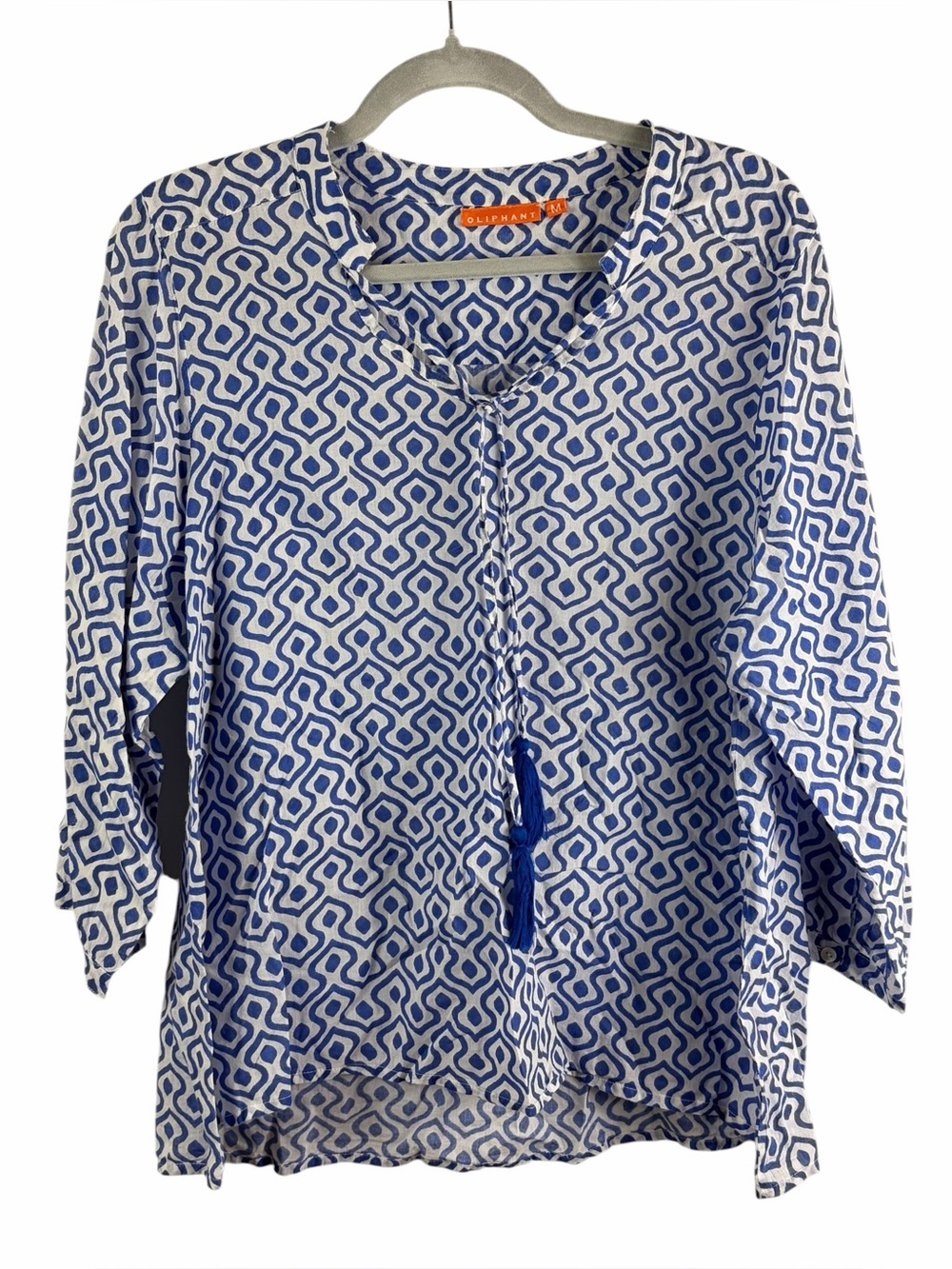 Oliphant blue geometric print blouse features a tassel tie neckline